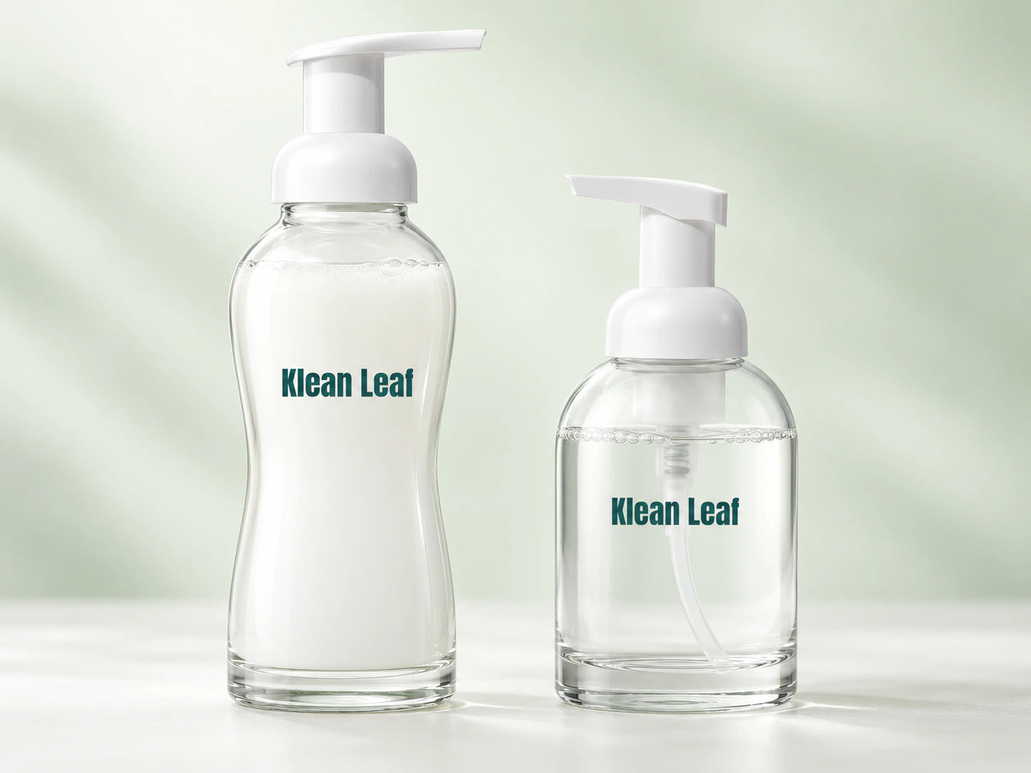 Two Klean Leaf glass foaming bottles with white pump dispensers